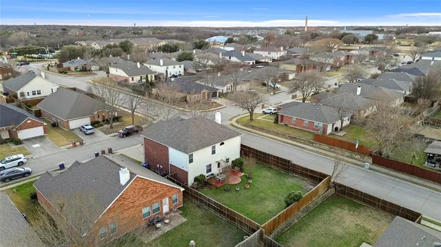 an aerial view of residential houses with outdoor space