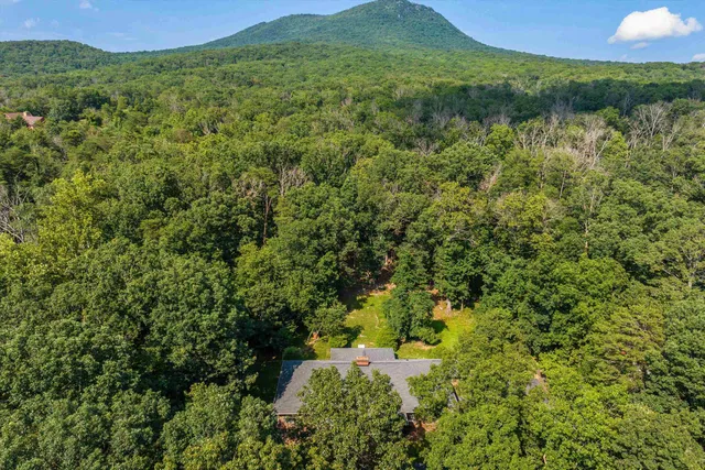 an aerial view of a house with a yard