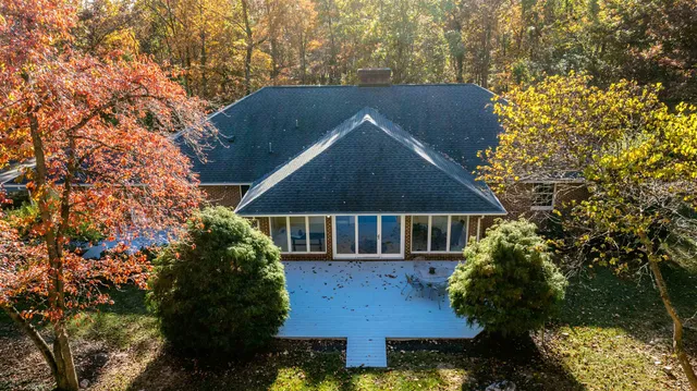 a bedroom with a bed and a lamp next to a window