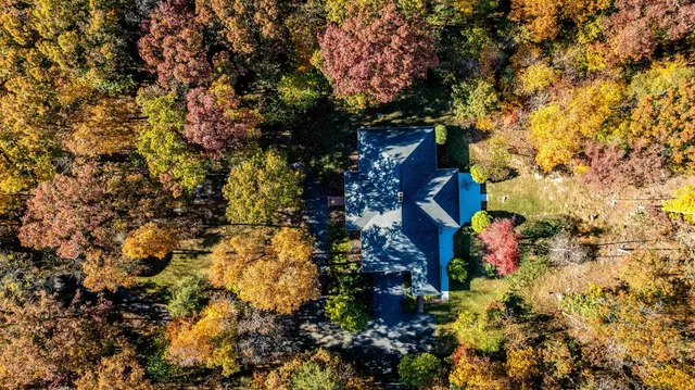 a bedroom with a bed and a lamp next to a window