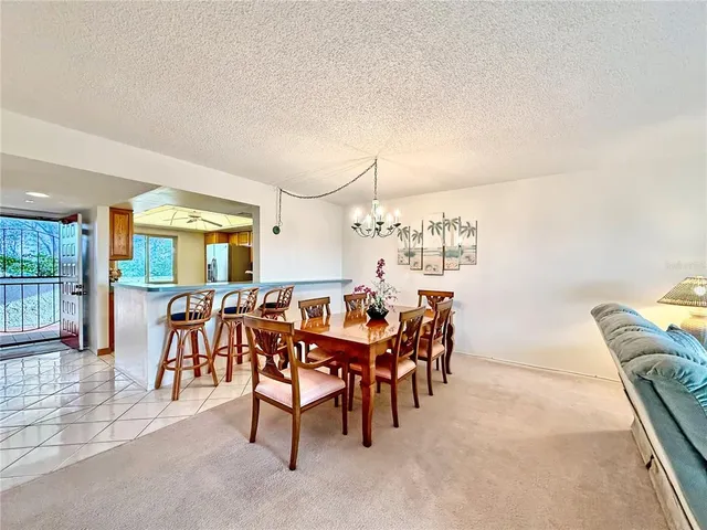 a view of a dining room with furniture and chandelier