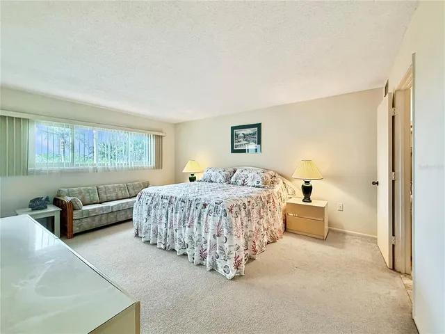 a spacious bedroom with a bed and a couch