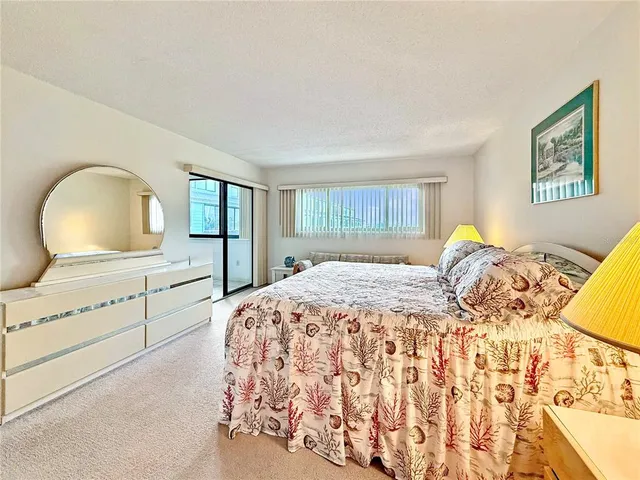 a bedroom with a large bed and a dresser