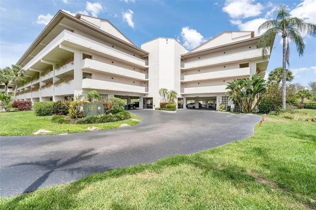 a sign board with buildings in the background