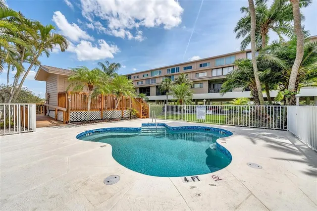 a living room with furniture a bookshelf and a window
