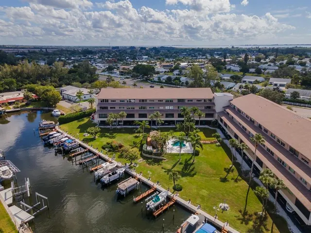 an aerial view of a resort with a swimming pool and lake view