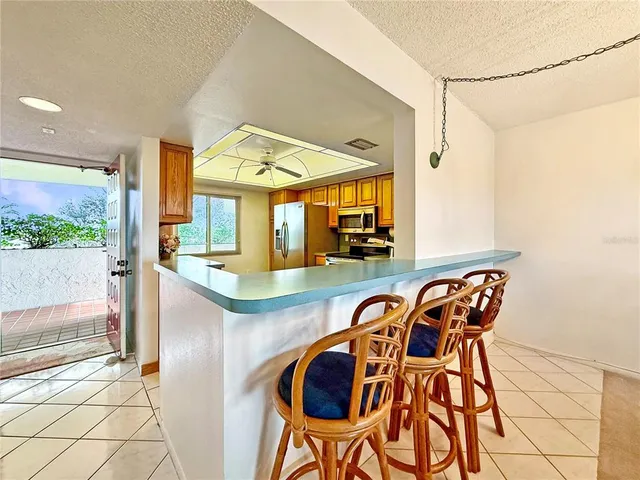 a view of a kitchen and dining area with chandelier