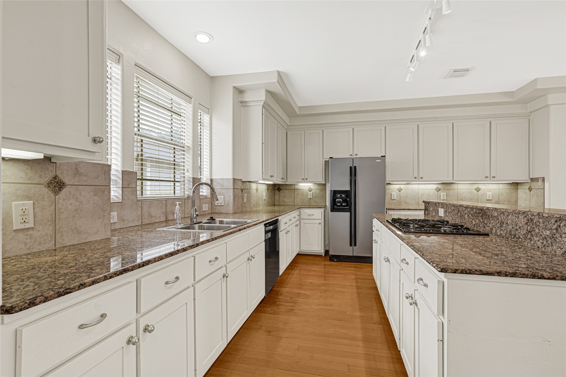 2414 Calumet Street, Unit B Houston, TX 77004 - Photo 12 of 27 a kitchen with granite countertop a sink a counter space appliances and cabinets