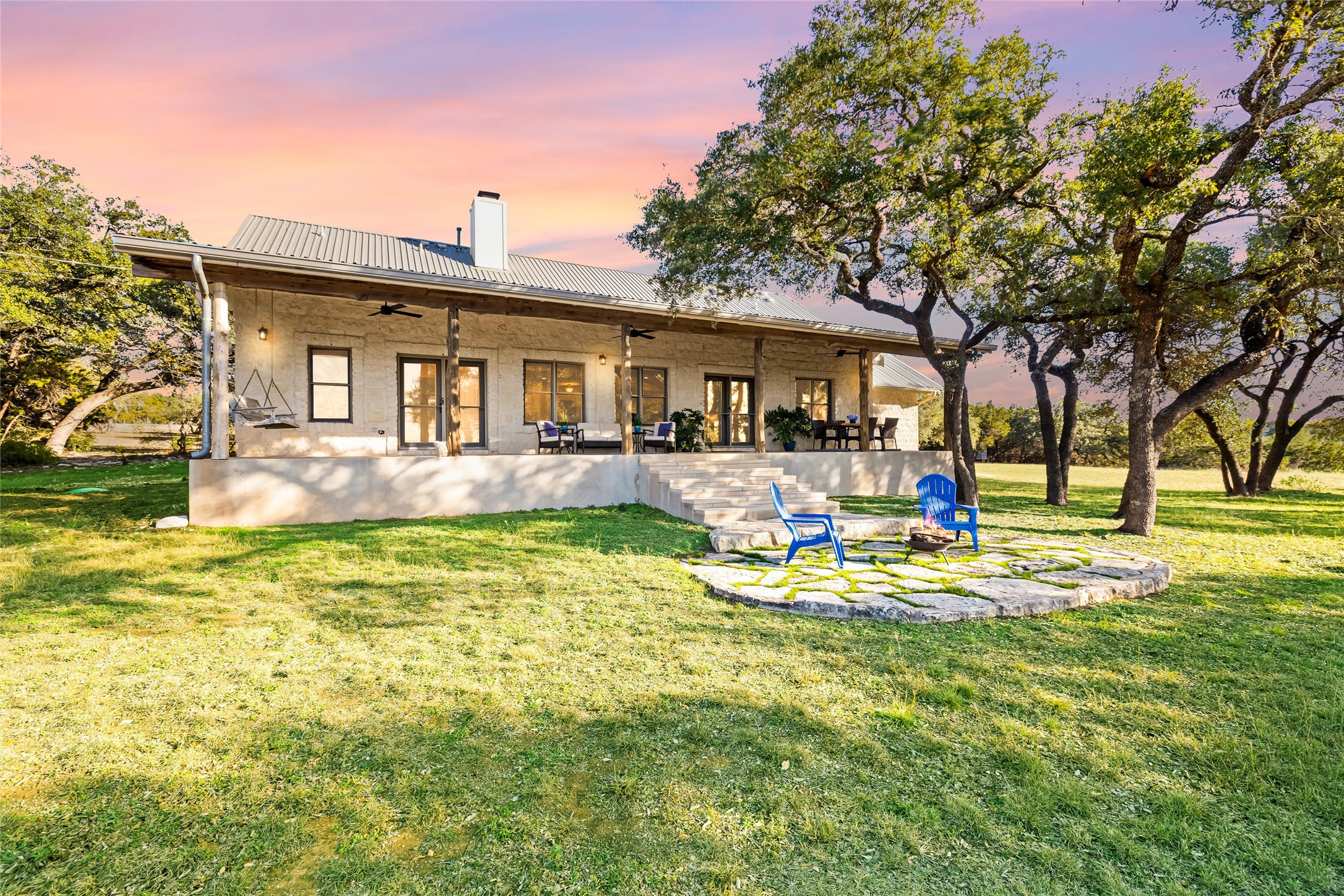 300 Sundown Ridge Austin, TX 78737 - Photo 34 of 40 a front view of house with outdoor seating and covered with trees