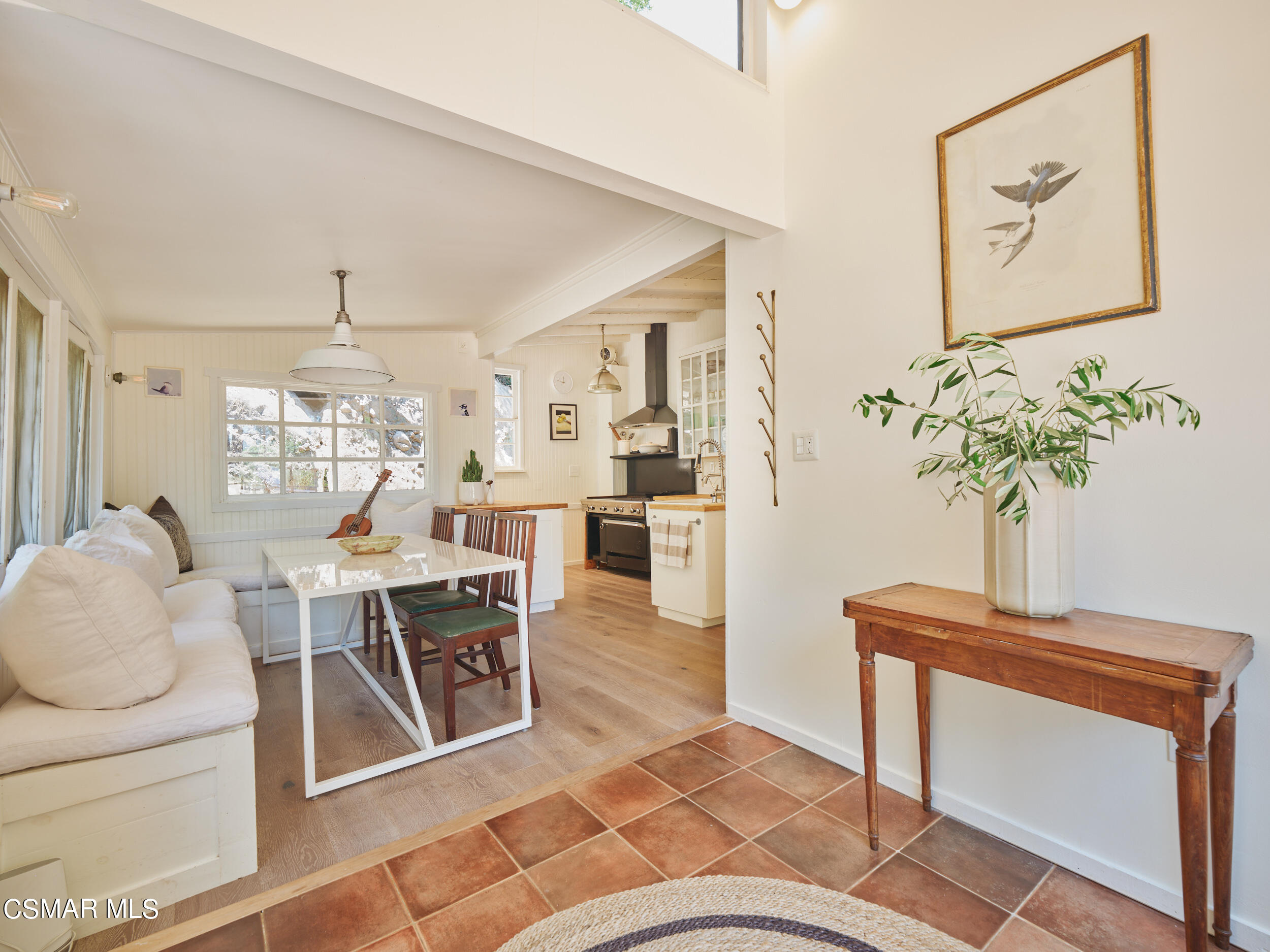 19833 Observation Drive Topanga, CA 90290 - Photo 17 of 75 a living room with furniture a chandelier and a dining table