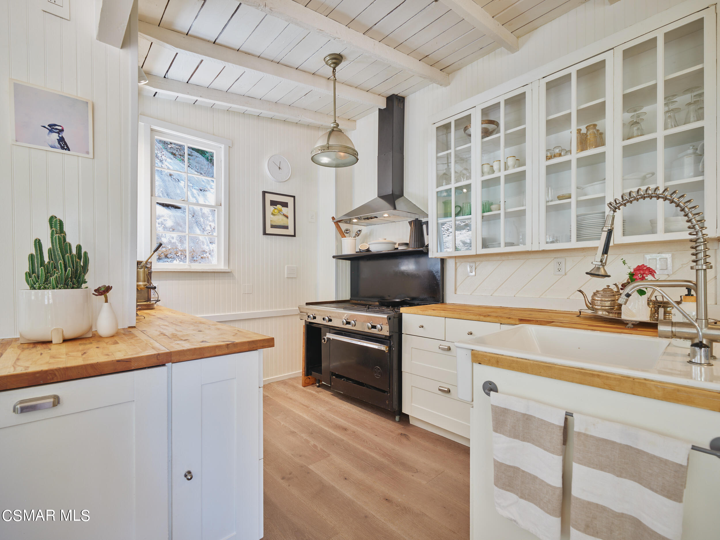 19833 Observation Drive Topanga, CA 90290 - Photo 19 of 75 a kitchen with a sink stove and cabinets