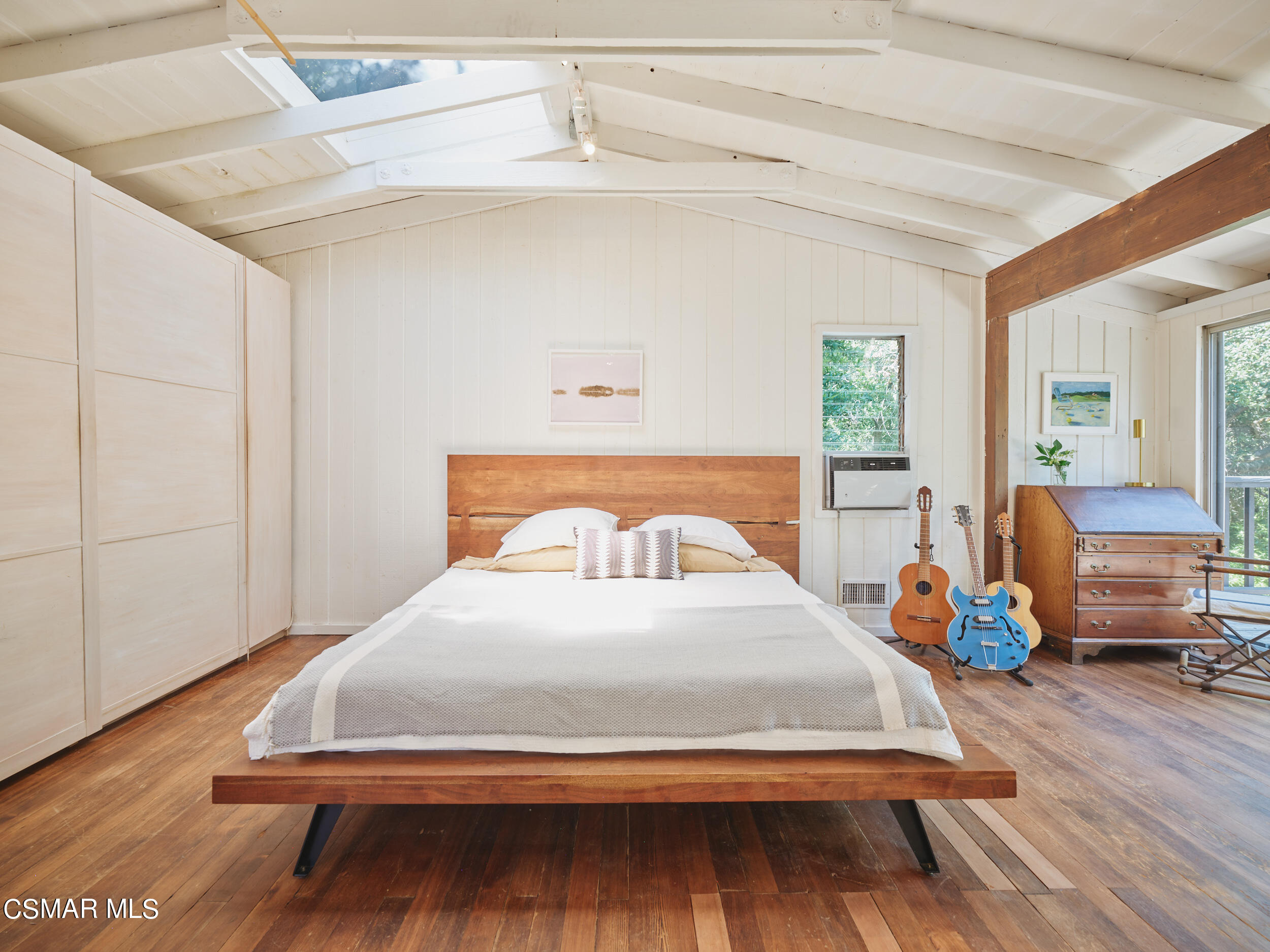 19833 Observation Drive Topanga, CA 90290 - Photo 33 of 75 a bedroom with a bed and wooden floor