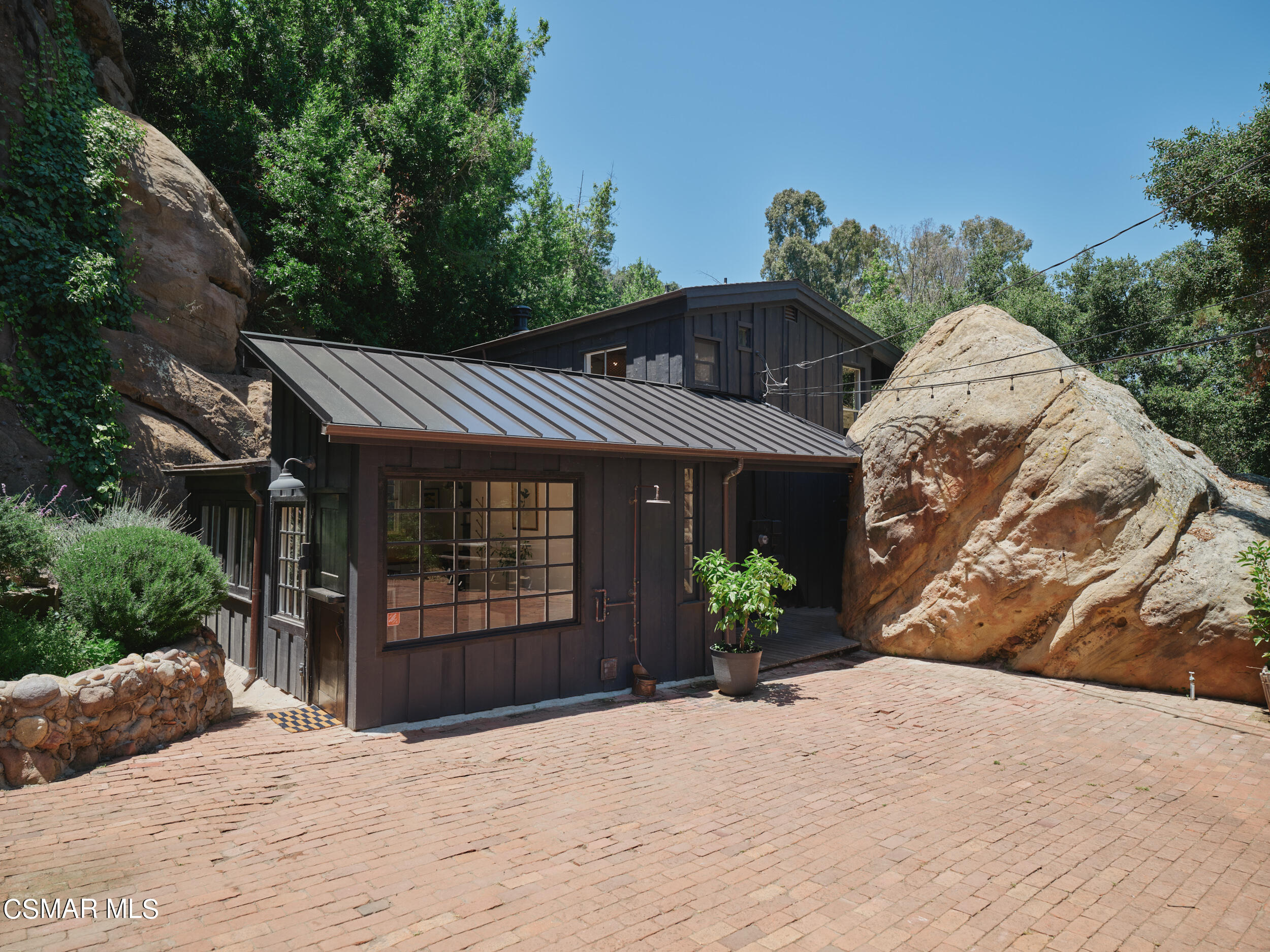 19833 Observation Drive Topanga, CA 90290 - Photo 45 of 75 a front view of a house with a yard and potted plants
