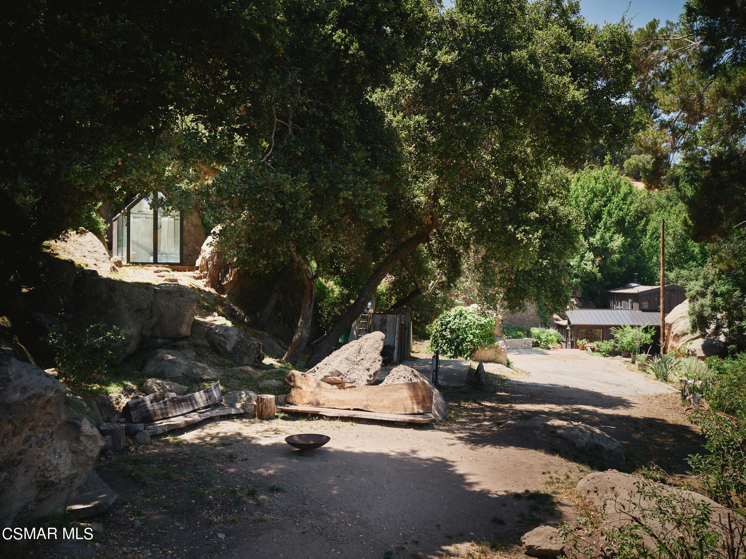 19833 Observation Drive Topanga, CA 90290 - Photo 63 of 75 a view of backyard with a table and chairs under an umbrella