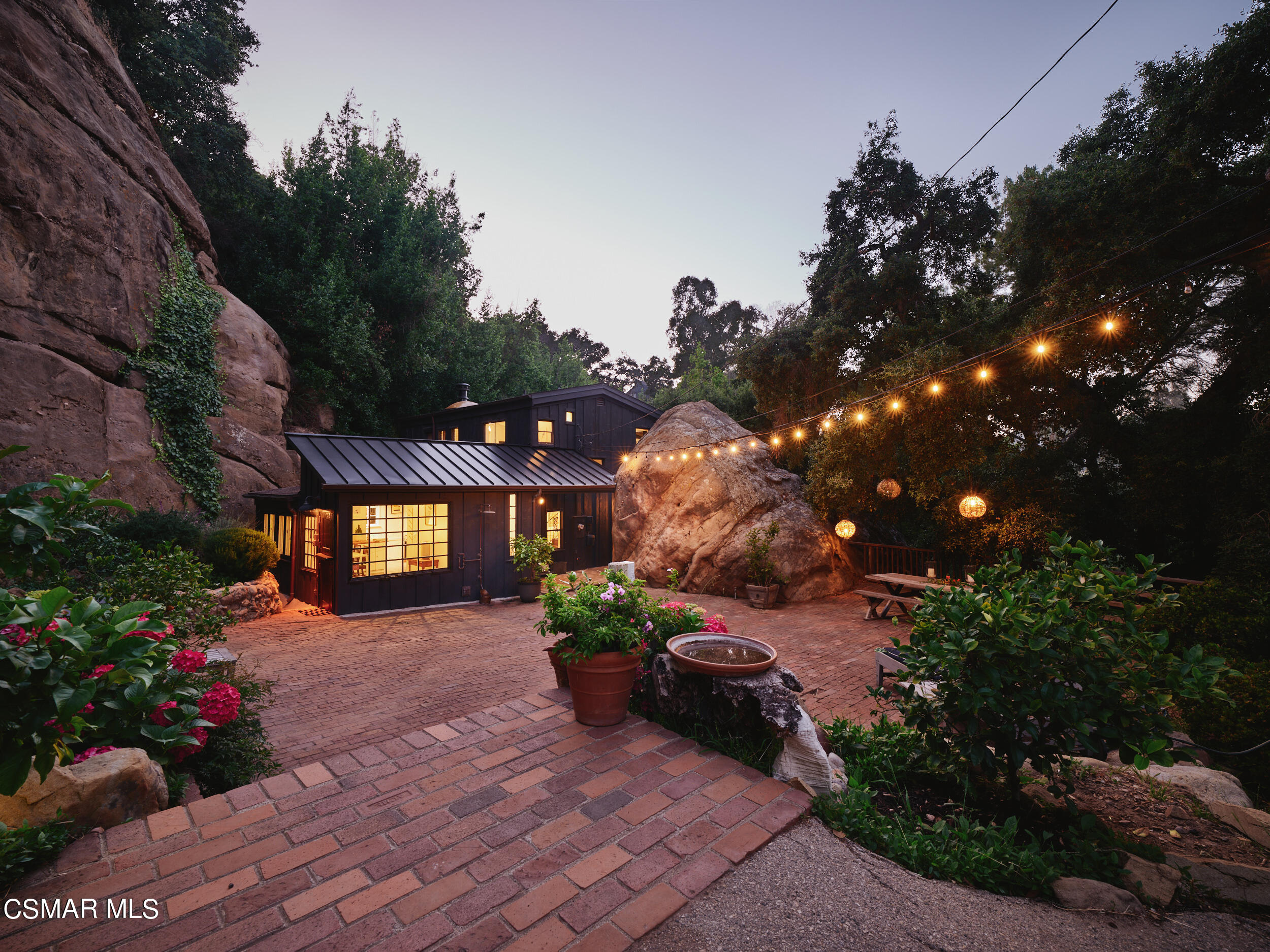 19833 Observation Drive Topanga, CA 90290 - Photo 75 of 75 a front view of a house with a yard and a garden
