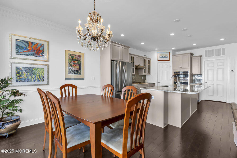 26 Malcolm Way Lincroft, NJ 07738 - Photo 12 of 44 a dining room with furniture a chandelier and window