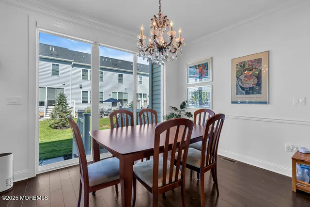 a view of a dining room with furniture wooden floor and chandelier