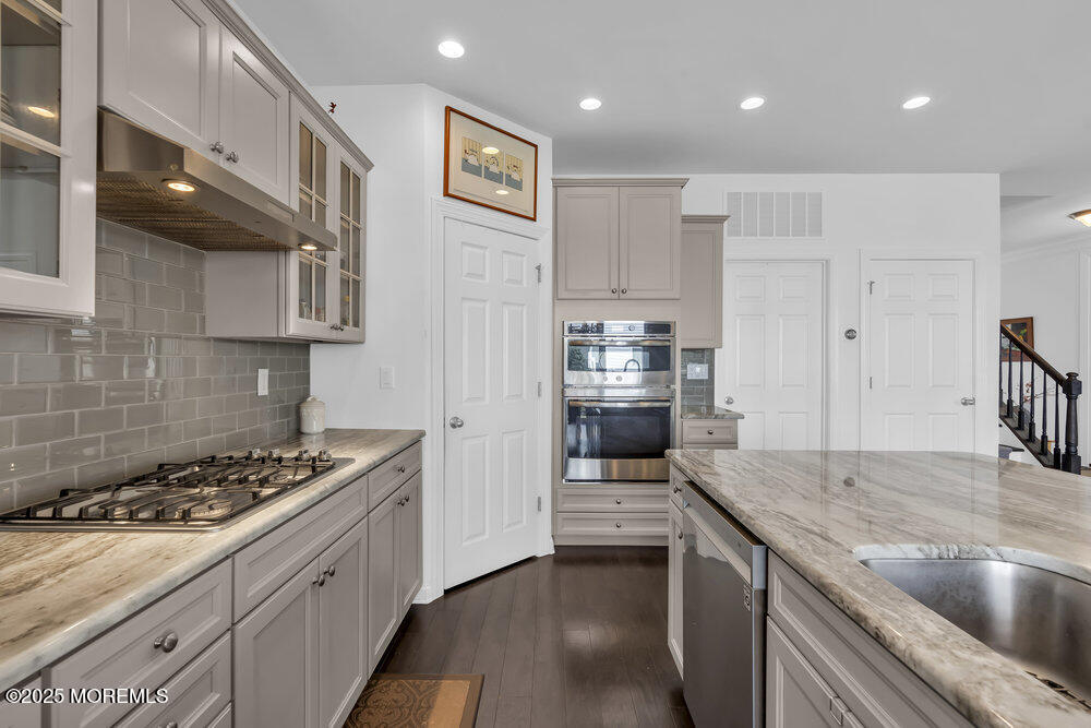 26 Malcolm Way Lincroft, NJ 07738 - Photo 18 of 44 a kitchen with stainless steel appliances granite countertop a sink stove and refrigerator