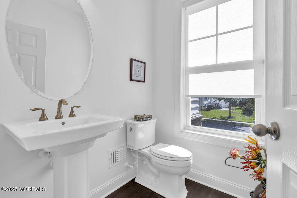 26 Malcolm Way Lincroft, NJ 07738 - Photo 22 of 44 a bathroom with a sink a toilet and a window