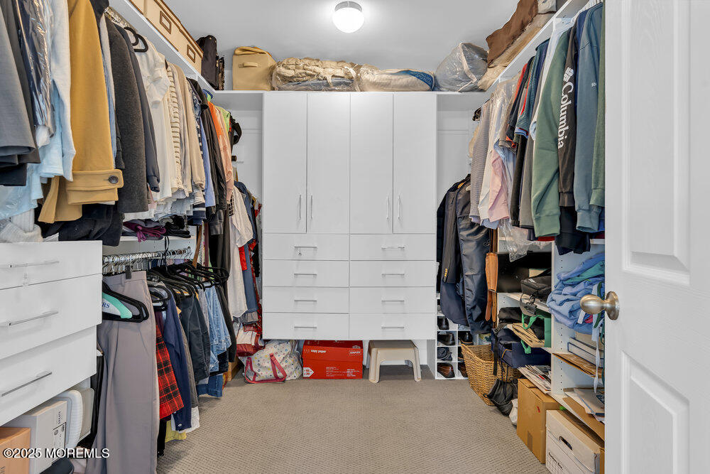26 Malcolm Way Lincroft, NJ 07738 - Photo 29 of 44 a view of walk in closet with clothes and shoes