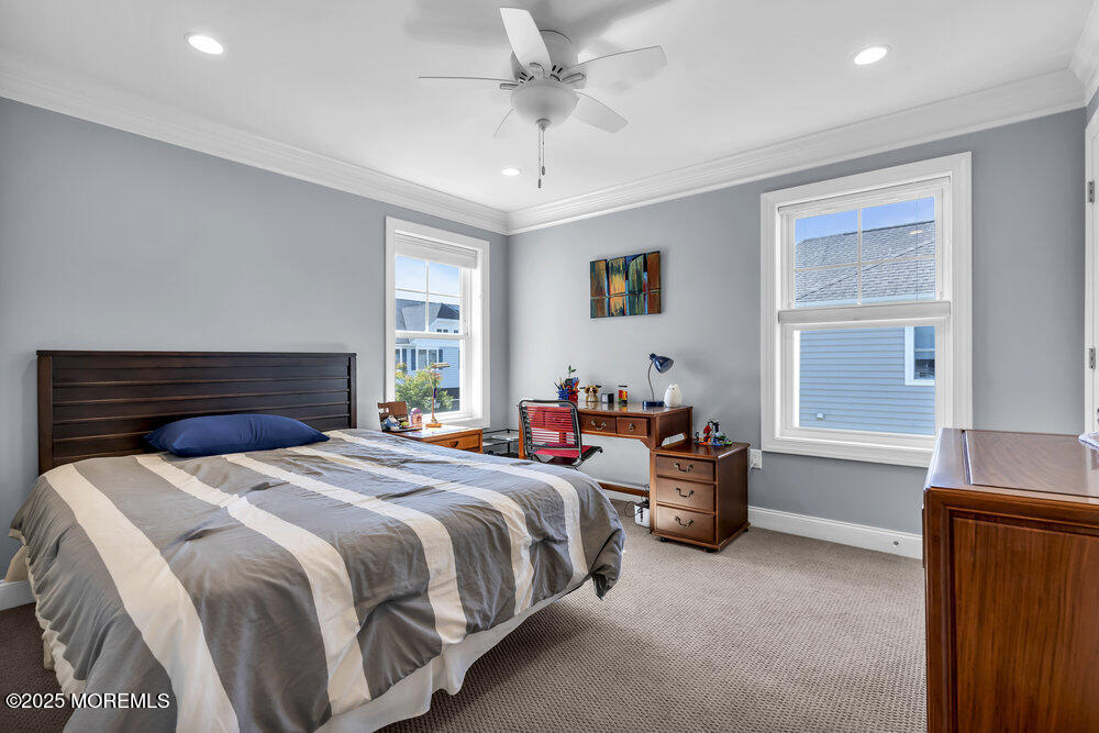 26 Malcolm Way Lincroft, NJ 07738 - Photo 30 of 44 a bedroom with a bed and a chandelier