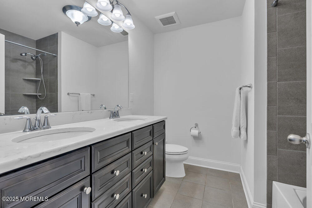 26 Malcolm Way Lincroft, NJ 07738 - Photo 32 of 44 a bathroom with a granite countertop sink a toilet and a mirror