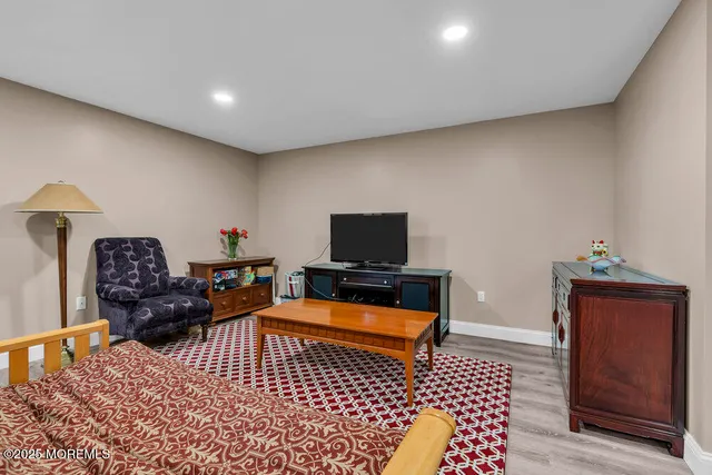 a bathroom with a sink a toilet a mirror and shower