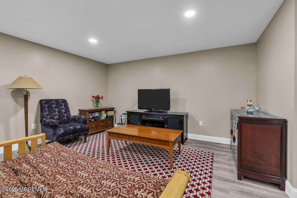 26 Malcolm Way Lincroft, NJ 07738 - Photo 36 of 44 a living room with furniture and a flat screen tv