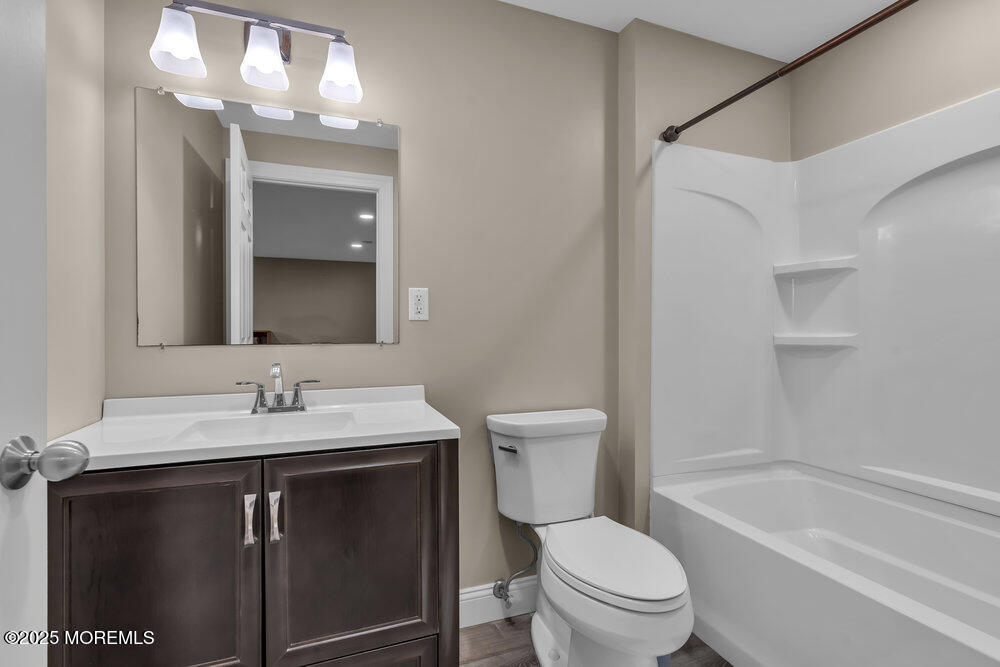 26 Malcolm Way Lincroft, NJ 07738 - Photo 37 of 44 a bathroom with a sink a toilet a mirror and shower