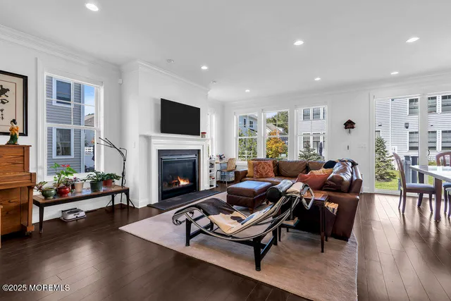 a living room with furniture fireplace and flat screen tv