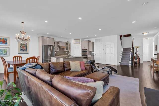 a living room with furniture and a chandelier