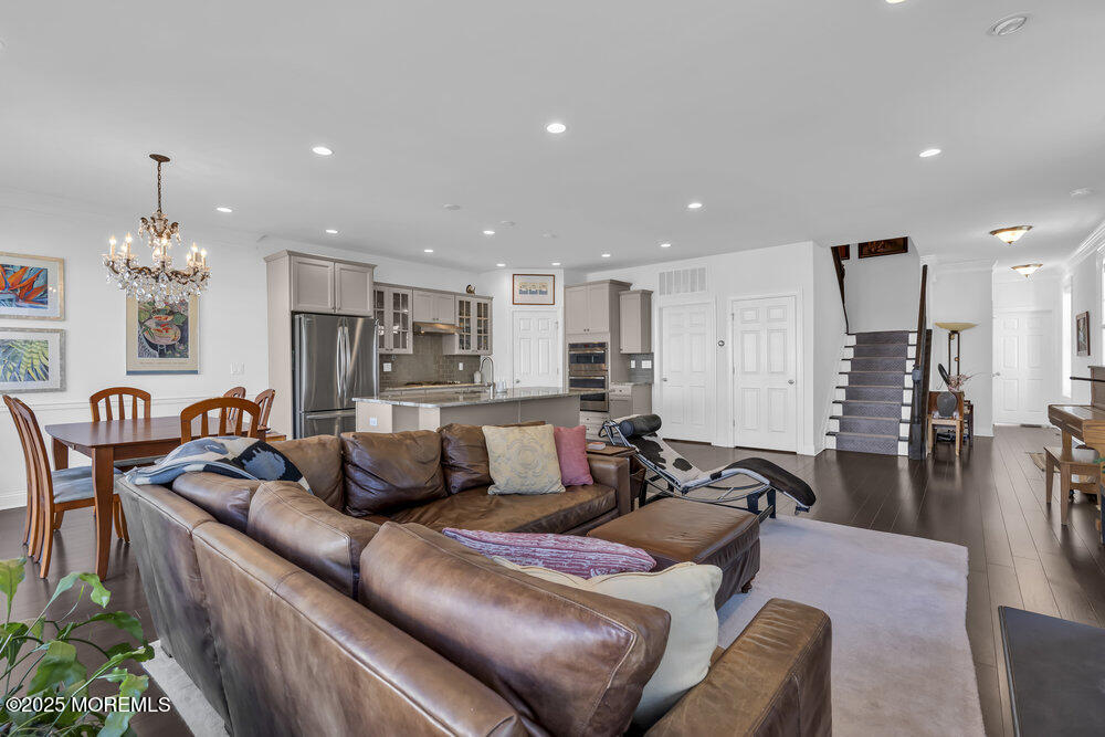 26 Malcolm Way Lincroft, NJ 07738 - Photo 10 of 44 a living room with furniture and a chandelier