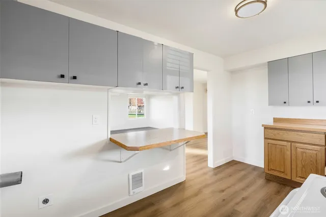 a kitchen with granite countertop white cabinets and a sink