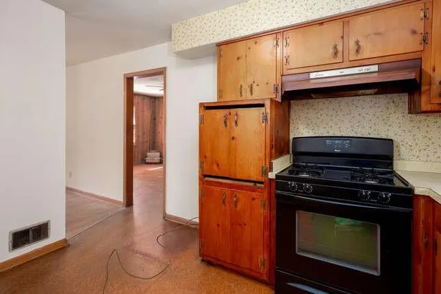 a kitchen with stainless steel appliances granite countertop a stove and a refrigerator