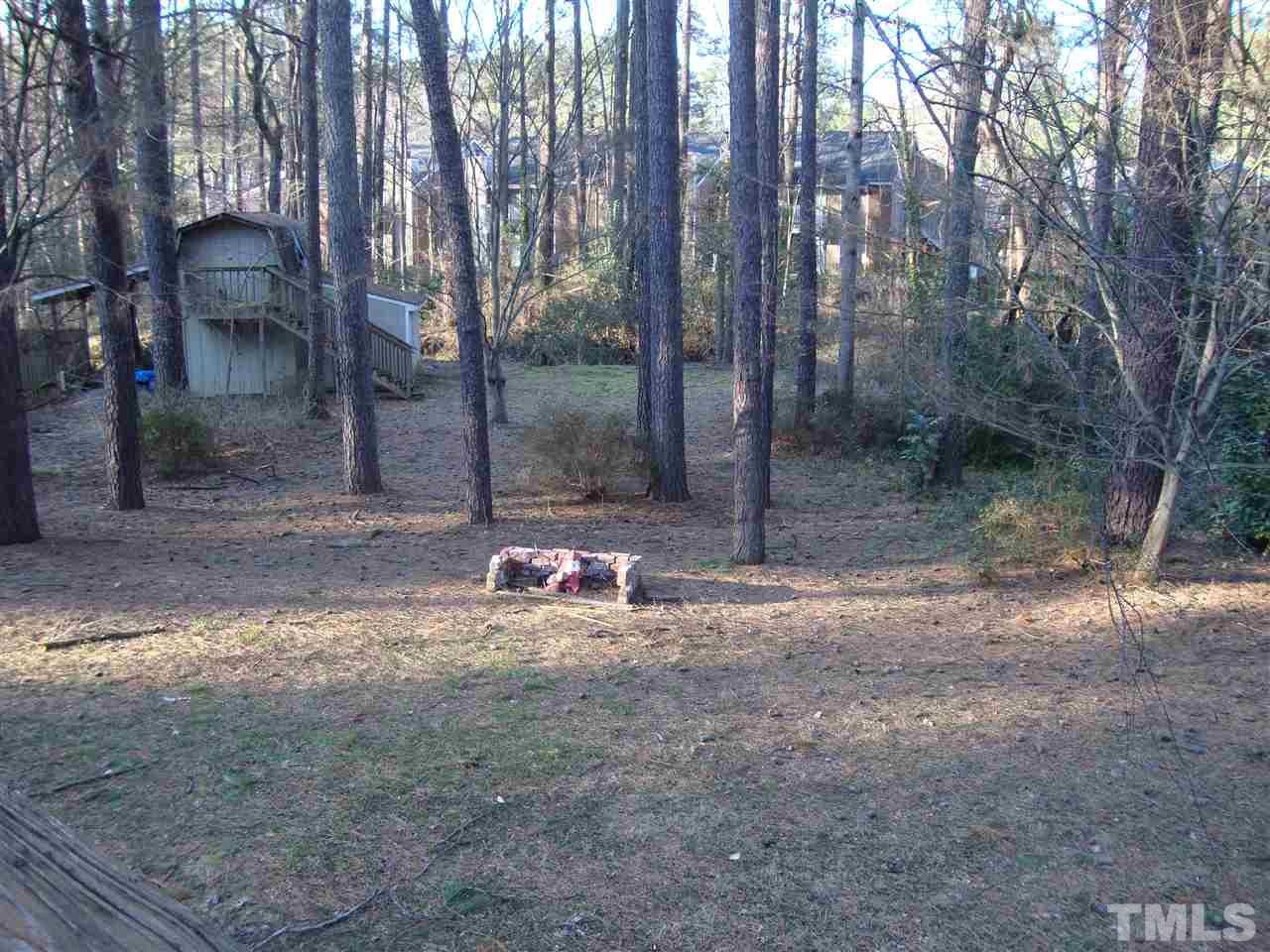 6901 Brecken Ridge Avenue Raleigh, NC 27615 - Photo 16 of 17 Or, you can cook in the pit in the yard. Notice the storage barn in the back. (This also has a semi room on the second floor-steps on the outside.) Has the makings of a tree house.