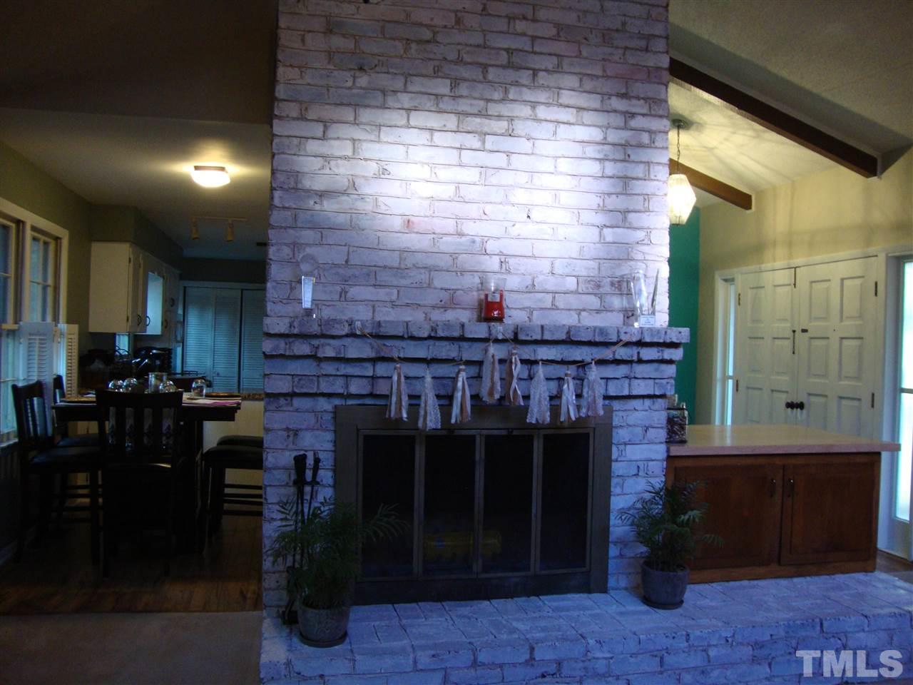 Wood burning fireplace is the center focus of the living room.