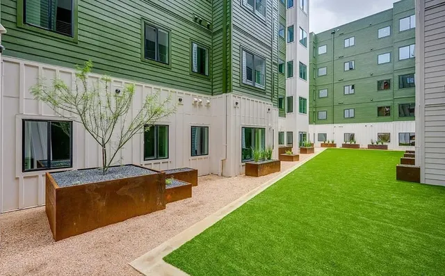 a view of a patio with couches and table and chairs with potted plants