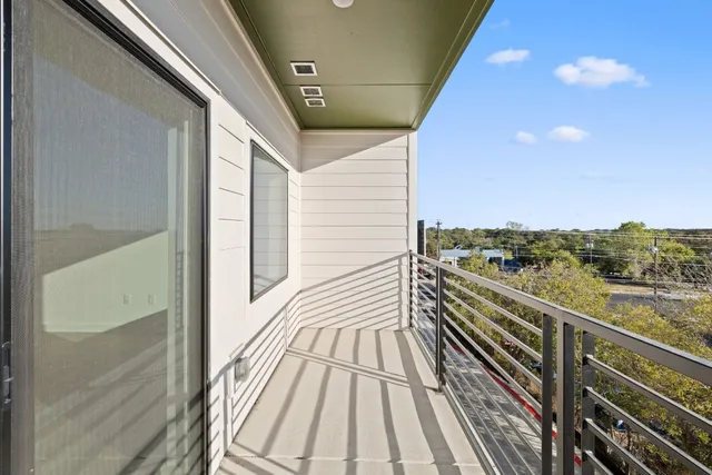 a view of a balcony with wooden floor