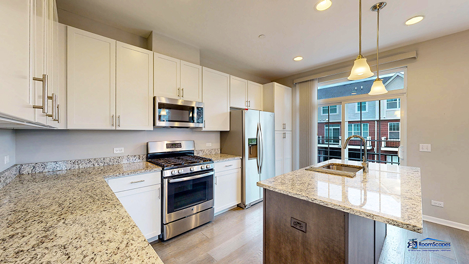 1255 Danforth Court Vernon Hills, IL 60061 - Photo 3 of 17 a kitchen with granite countertop a stove a sink a refrigerator and a microwave