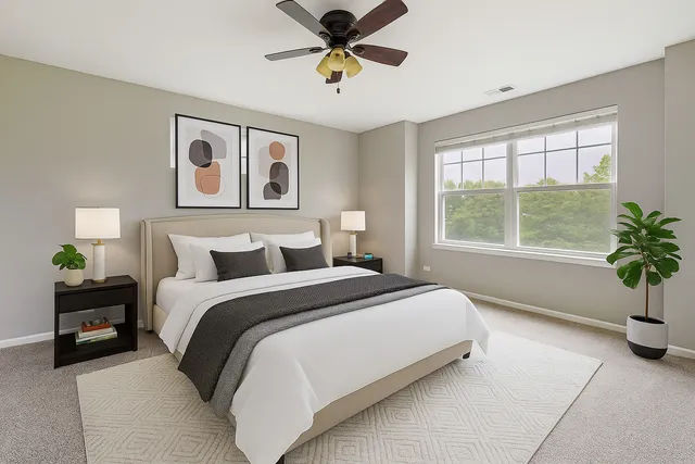 a spacious bedroom with a bed and a window