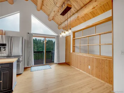 a kitchen with stainless steel appliances granite countertop a stove a refrigerator a sink and dishwasher with wooden floor