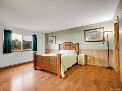 a bed sitting in a bedroom next to a window