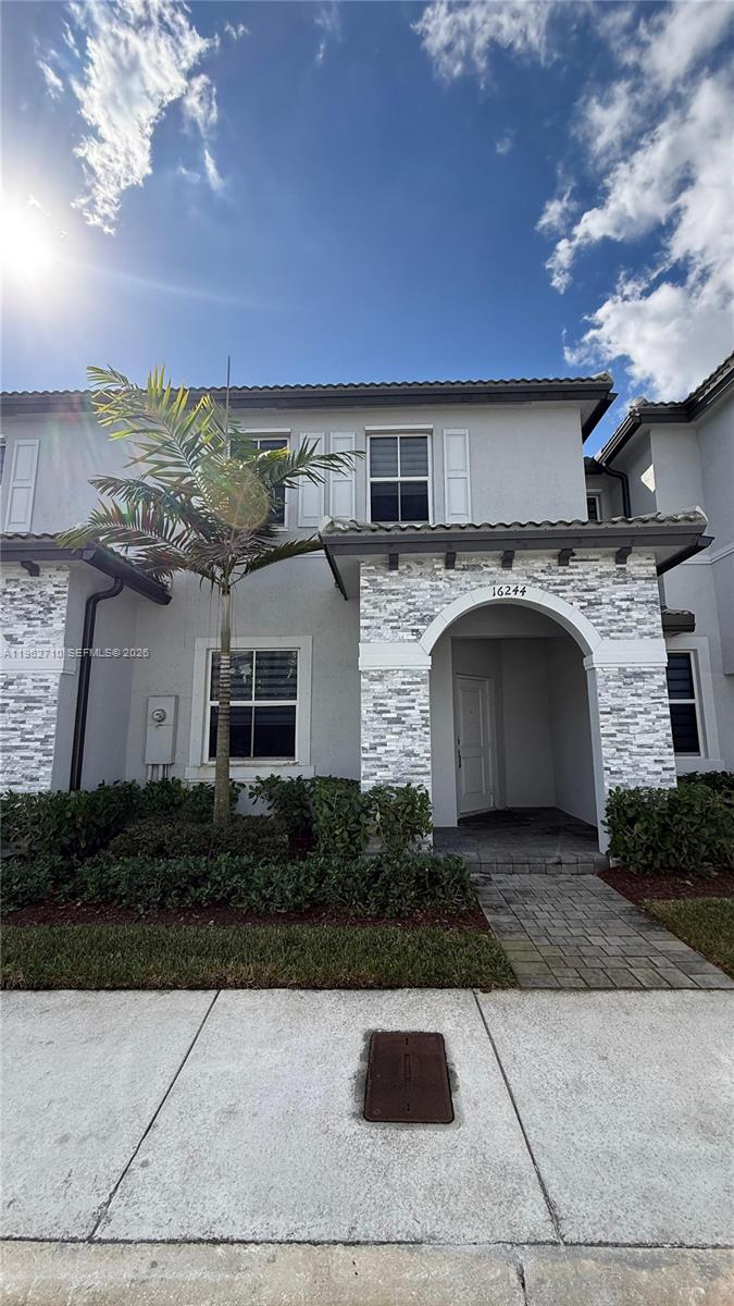16244 Southwest 291st Street, Unit 16244 Homestead, FL 33033 - Photo 1 of 49 a front view of a house with yard