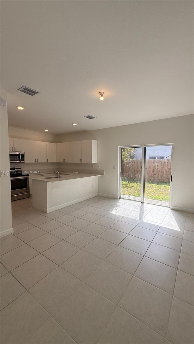 16244 Southwest 291st Street, Unit 16244 Homestead, FL 33033 - Photo 13 of 49 a view of a kitchen with a sink and a refrigerator