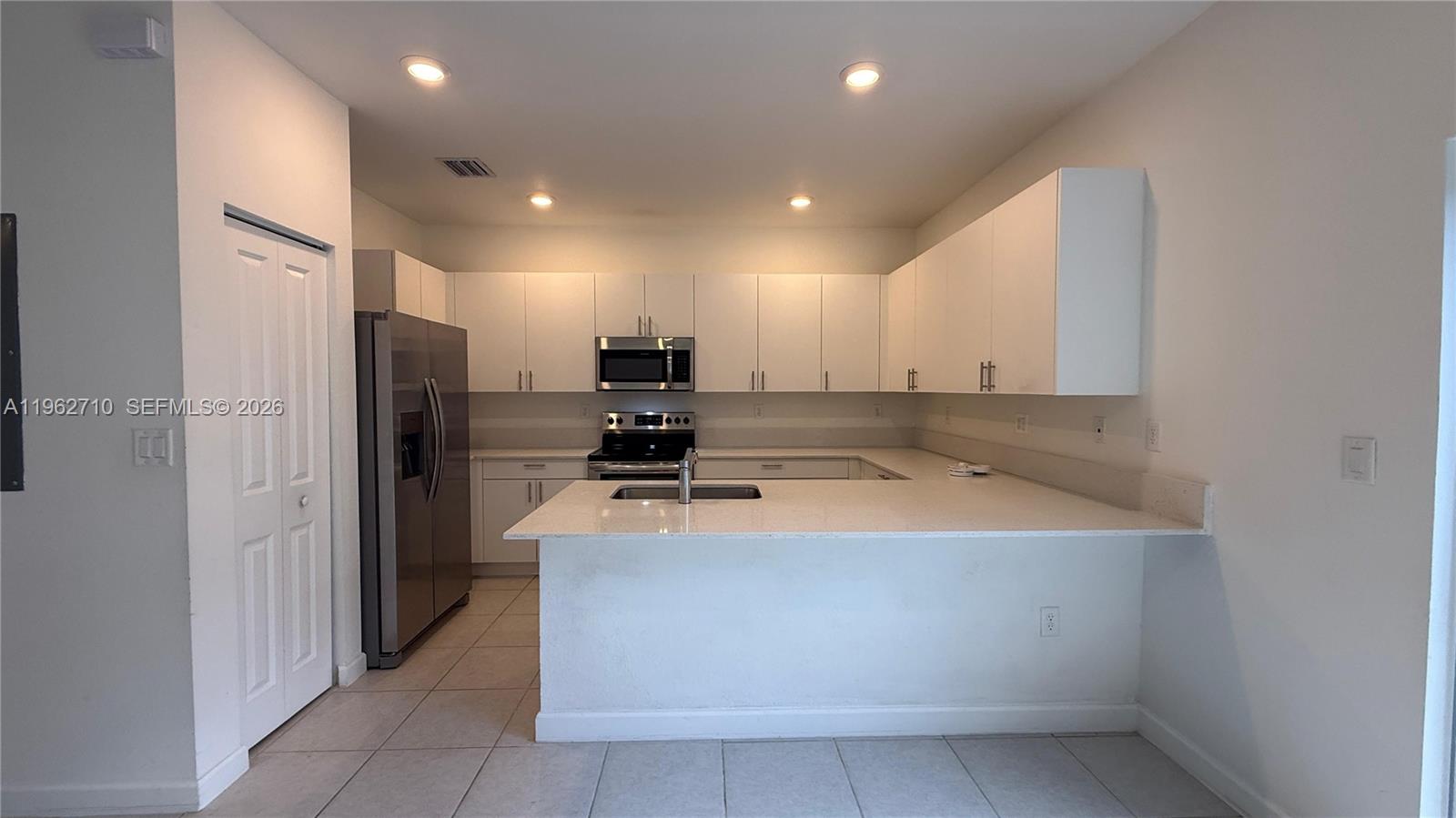 16244 Southwest 291st Street, Unit 16244 Homestead, FL 33033 - Photo 14 of 49 a kitchen with stainless steel appliances granite countertop a refrigerator and a sink