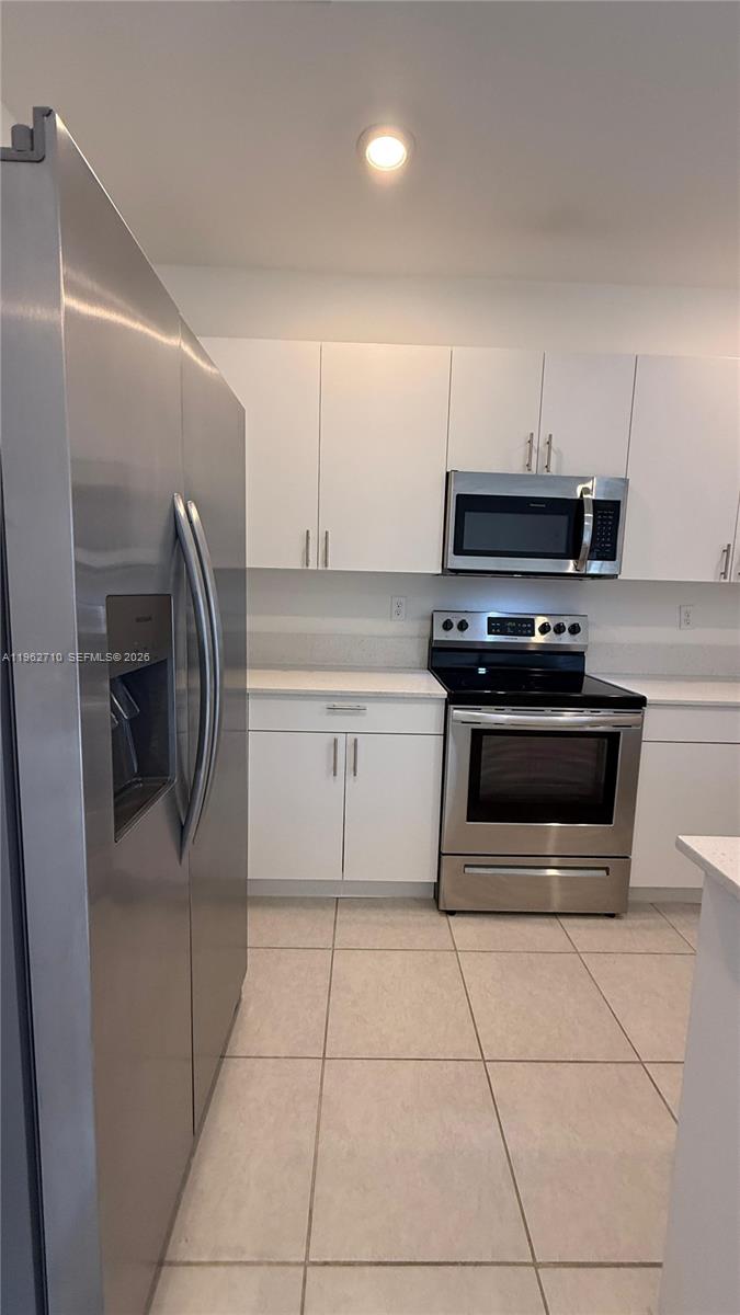 16244 Southwest 291st Street, Unit 16244 Homestead, FL 33033 - Photo 16 of 49 a kitchen with cabinets and steel stainless steel appliances