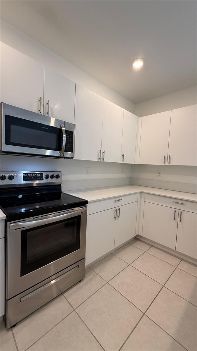 16244 Southwest 291st Street, Unit 16244 Homestead, FL 33033 - Photo 17 of 49 a kitchen with cabinets stainless steel appliances and a counter space