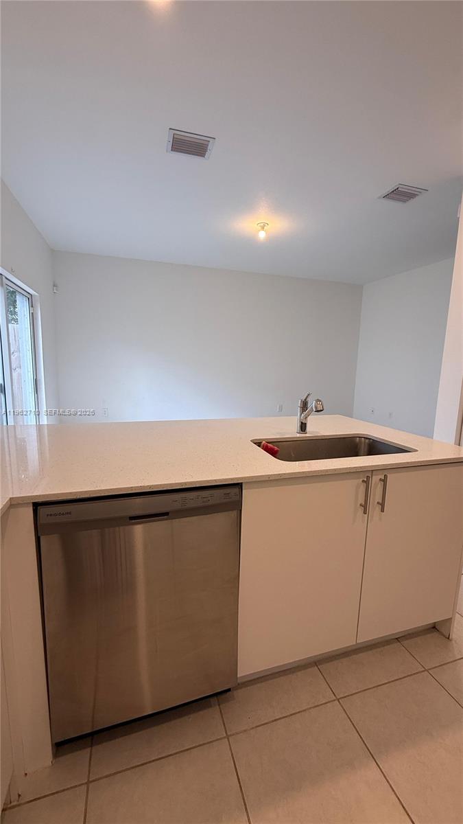 16244 Southwest 291st Street, Unit 16244 Homestead, FL 33033 - Photo 20 of 49 a kitchen with a sink and cabinets