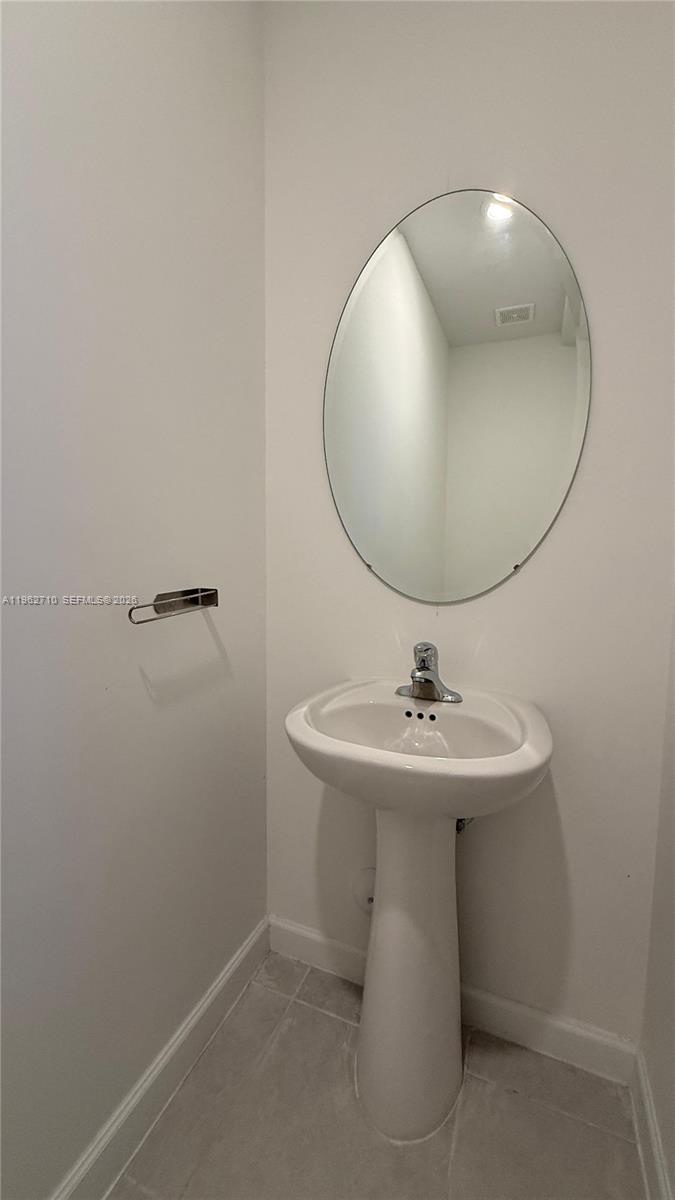 16244 Southwest 291st Street, Unit 16244 Homestead, FL 33033 - Photo 21 of 49 a bathroom with a sink a mirror and vanity