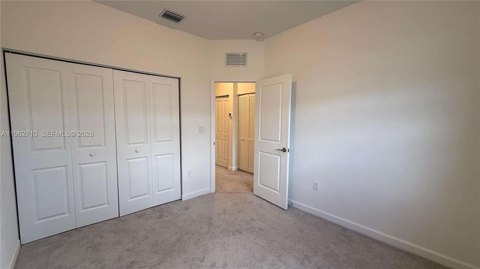 16244 Southwest 291st Street, Unit 16244 Homestead, FL 33033 - Photo 36 of 49 an empty room with windows and closet